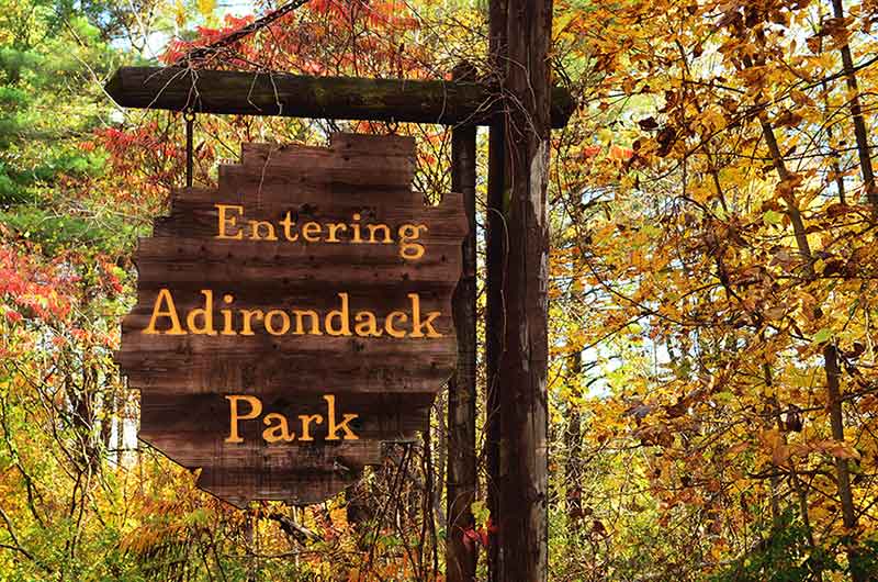 Entering Adirondack Park Sign against fall foliage